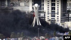 Khói đen bốc lên từ các lều trại bị đốt ở Quảng trường Pearl tại thủ đô Manama, ngày 16/3/2011