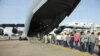 Indian nationals board an Indian Air Force plane July 14, 2016, as they leave Entebbe, Uganda, to go back home after arriving from Juba, South Sudan. India and other nations continue to evacuate citizens from South Sudan, where fears of a return to civil war persist. 