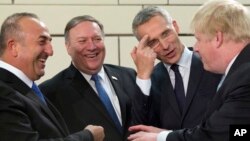 From left, Turkish Foreign Minister Mevlut Cavusoglu, U.S. Secretary of State Mike Pompeo, NATO Secretary General Jens Stoltenberg and British Foreign Secretary Boris Johnson speak prior to a meeting of NATO foreign ministers at NATO headquarters in Brussels, April 27, 2018.