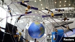 FILE - A model of the BeiDou navigation satellite system is seen at an exhibition to mark China's Space Day 2019 on April 24, in Changsha, Hunan province, China, April 23, 2019.