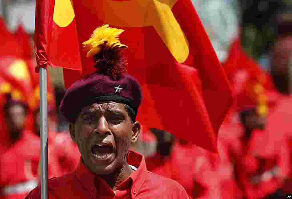 An activist of Sri Lanka's Marxist political party, People's Liberation Front shouts out instructions during a street march to celebrate international Labor Day known as May Day in Colombo, Sri Lanka, May 1, 2012. (AP Photo)