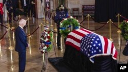 President Joe Biden pays respects to former Senate Majority Leader Harry Reid, of Nev., who is lying in state in the Rotunda of the U.S. Capitol, Jan. 12, 2022, in Washington.