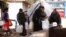 People queue as they fill containers with water in the government controlled al-Rabwah area, a suburb of Damascus, Jan. 10, 2017. 