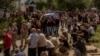 Men carry coffins during the funeral of six Ukrainian servicemen, who were killed since Ukraine launched its offensive at the Russian border region of Kursk, in Sumy, northeastern Ukraine, Aug. 15, 2024.