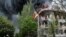 A police station is ablaze in Mariupol, eastern Ukraine. Fighting between government forces and insurgents in the city left several people dead on Friday.