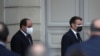 French President Emmanuel Macron, right, and Egyptian President Abdel-Fattah el-Sissi arrive for a joint news conference at the Elysee palace, in Paris, France, Dec. 7, 2020.