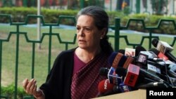 FILE - Chief of India's ruling Congress party Sonia Gandhi (R) speaks during a news conference in New Delhi.