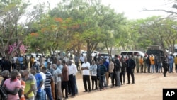 Residents lineup to cast their vote, Oct. 28, 2020, in Dodoma, Tanzania, for a presidential election that the opposition warns is already deeply compromised by manipulation and deadly violence. 