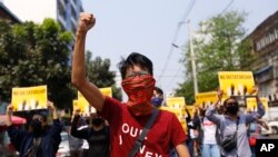 FILE - In this photo taken on March 26, 2021, anti-coup protesters gesture during a march in Yangon, Myanmar.