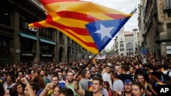 Demonstrators with "estelada," or Catalonia independent flag, gather in protest in front of the Spanish police station in Barcelona, Spain, Oct. 3, 2017.