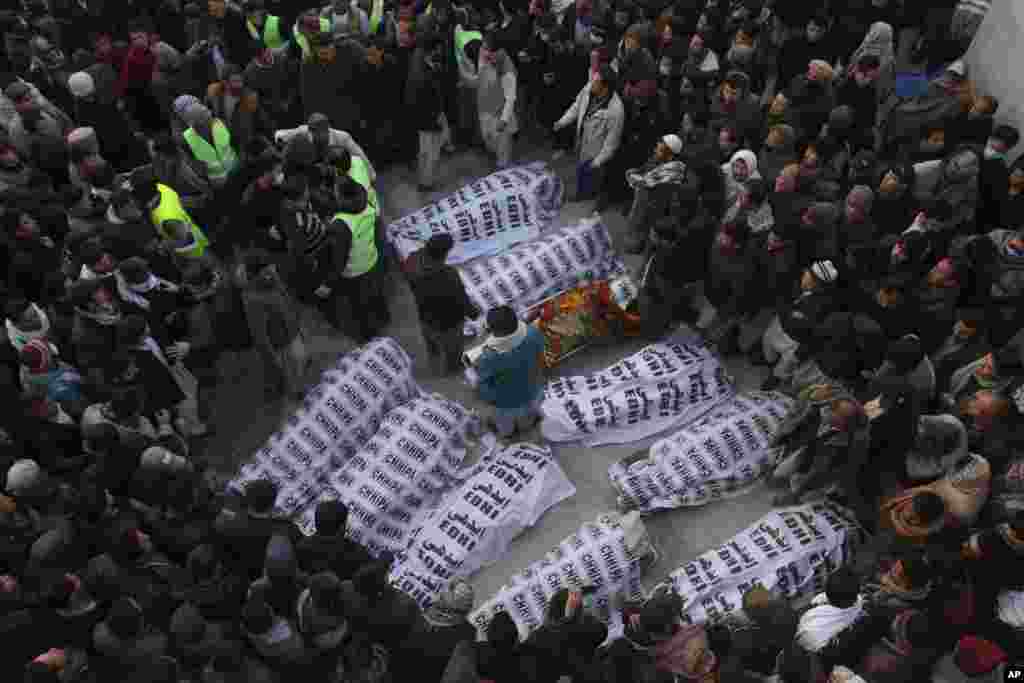 People from the Shi&#39;ite Hazara community gather around the bodies of coal mine workers who were killed by unknown gunmen near the Machh coal field, in Quetta, Pakistan.