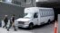 FILE - A vehicle carrying asylum-seekers brought from Tijuana, Mexico, to the United States for their immigration hearings arrives at a court in San Diego, Calif., March 19, 2019.
