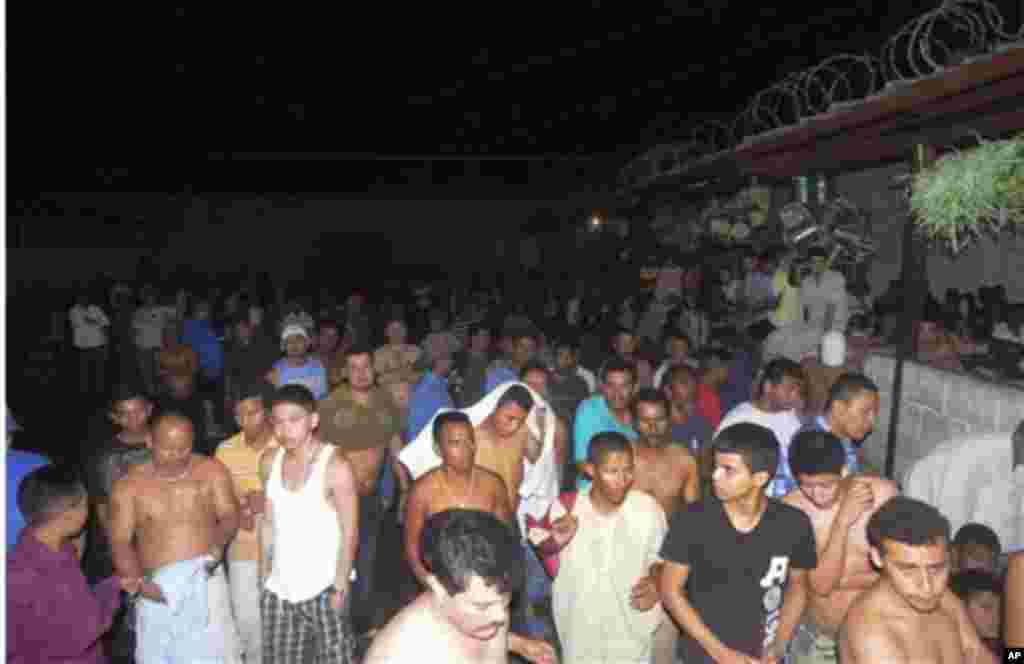 Inmates stand in the courtyard of the prison after a fire broke out in Comayagua, Honduras. The fire claimed the lives of at least 300 inmates. (AP)