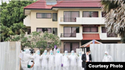 Thai medical staff stand in front of a facility at the Satthahip Naval Base, where Thai citizens who were evacuated from Wuhan, China, are quarantined for 14 days after their arrival, Feb. 4, 2020.