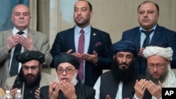 Taliban political chief Sher Mohammad Abbas Stanikzai, first row second from left, Abdul Salam Hanafi and other Taliban official pray during the "intra-Afghan" talks in Moscow, Russia, Wednesday, Feb. 6, 2019. The U.S. has promised to withdraw half…
