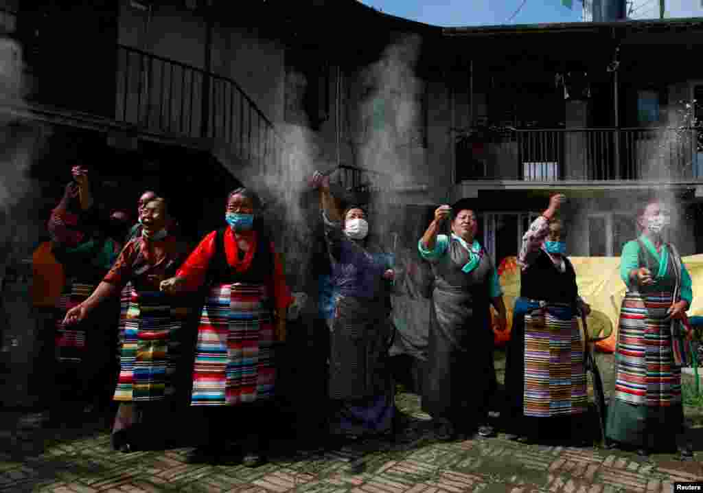 Tibetans dressed in traditional attire perform rituals to mark the 86th birthday celebration of Dalai Lama in Lalitpur, Nepal, July 6, 2021.