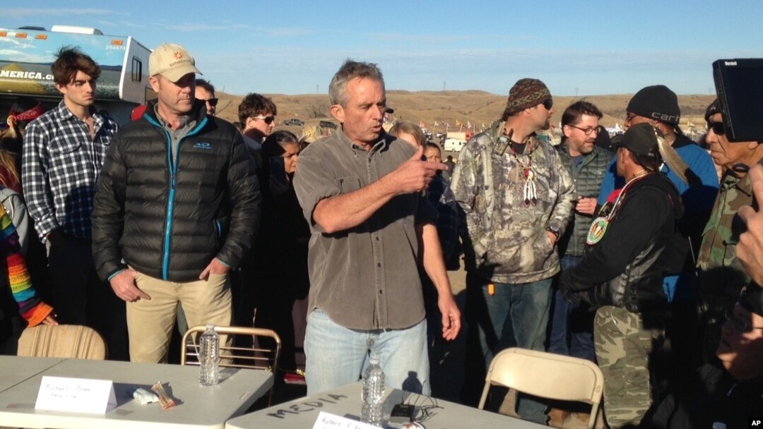 Robert F. Kennedy Jr., center, an environmental attorney and president of the New York-based Waterkeeper Alliance, speaks with opponents of the Dakota Access oil pipeline at the main protest camp, Nov. 15, 2016, near Cannon Ball, N.D.