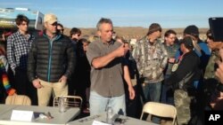 Robert F. Kennedy Jr., center, an environmental attorney and president of the New York-based Waterkeeper Alliance, speaks with opponents of the Dakota Access oil pipeline at the main protest camp, Nov. 15, 2016, near Cannon Ball, N.D.