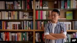 Yu Miao, owner of JF Books, poses for a photo in his bookstore in Washington, Oct. 3, 2024. 