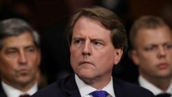 FILE PHOTO: White House Counsel Don McGahn listens to Judge Brett Kavanaugh as he testifies before the Senate Judiciary Committee during his Supreme Court confirmation hearing in the Dirksen Senate Office Building on Capitol Hill in Washington, U.S…
