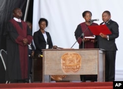 Mozambique's President Filipe Nyusi, right, during his inauguration ceremony in Maputo, Mozambique,Jan. 15, 2020. Nyusi has been sworn in for a second and final term after five turbulent years in office amid two armed insurgencies.