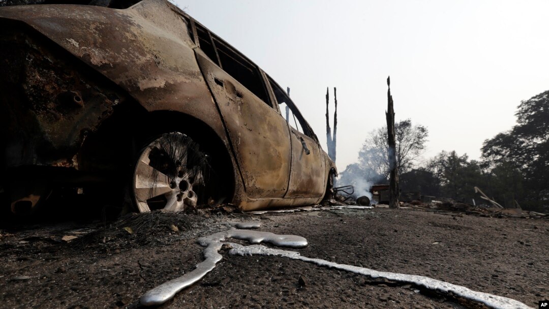 Melted metal is seen under a wildfire-damaged car, July 31, 2018, in Lakeport, California.