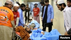 Injured men, who were rescued from a train after it was attacked by separatist militants, are brought to a hospital for treatment in Quetta, Pakistan, March 13, 2025. 