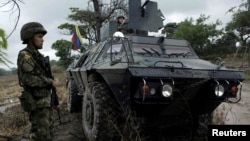 FILE - Colombian soldiers stand guard during a military operation at the border with Venezuela in Cucuta, Colombia, Feb. 13, 2018.