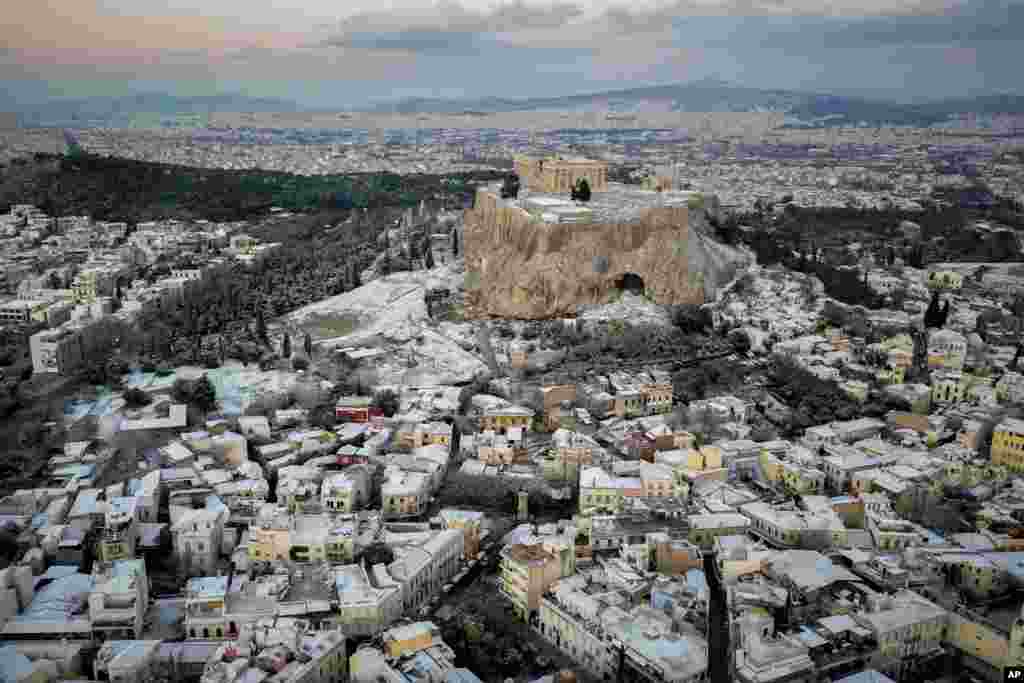 Snow covers parts of the ancient Acropolis and the Plaka neighborhood in Athens, Greece.