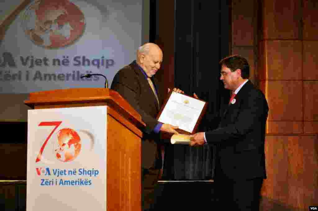 IBB Director DIck Lobo presents VOA Albanian Service Chief Arben Xhixho with the BBG's Certificate of Recognition