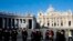 People walk in St. Peter's Square at the Vatican, February 19, 2013. 