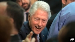 FILE - Former President Bill Clinton greets people in the audience after speaking in support of his wife, Democratic presidential candidate Hillary Clinton, at the Community College of Rhode Island in Warwick, R.I., April 14, 2016.