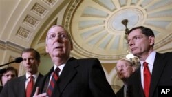 Senate Minority Leader Mitch McConnell of Ky., second from left, gestures during a news conference on Capitol Hill in Washington, Tuesday, Dec. 7, 2010. From left are, Sen. John Thune, R-S.D., McConnell, Sen. Lamar Alexander, R-Tenn., and Sen. John Barras