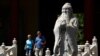 FILE - Tourists walk past a statue of philosopher Confucius in Beijing, May 28, 2019. At that time, China used five-day Confucian culture immersion courses for religious leaders as part of a campaign to extend government control over faith communities.