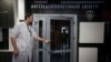 RUSSIA -- A staff member opens a door for journalists during a visit to Russia's national drug-testing laboratory in Moscow, May 24, 2016