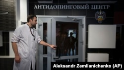 RUSSIA -- A staff member opens a door for journalists during a visit to Russia's national drug-testing laboratory in Moscow, May 24, 2016