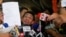 Maria Ressa, left, the award-winning head of a Philippine online news site Rappler that has aggressively covered President Rodrigo Duterte's policies, shows her release order after posting bail, Feb. 14, 2019 in Manila, Philippines. 