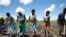 Women prepare land for crops as part of a World Food Program initiative helping communities recovering from the aftermath of last year's Cyclone Idai in Dondo, Mozambique, Feb. 27, 2020.