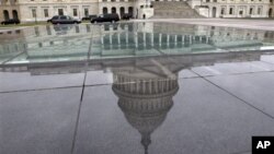 The dome of the Capitol is reflected in a skylight of the Capitol Visitor's Center in Washington, January 1, 2013.