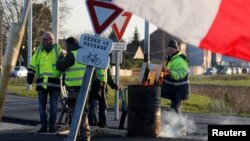 Protesters wearing yellow vests occupy a roundabout in Somain, France, Dec.13, 2018.