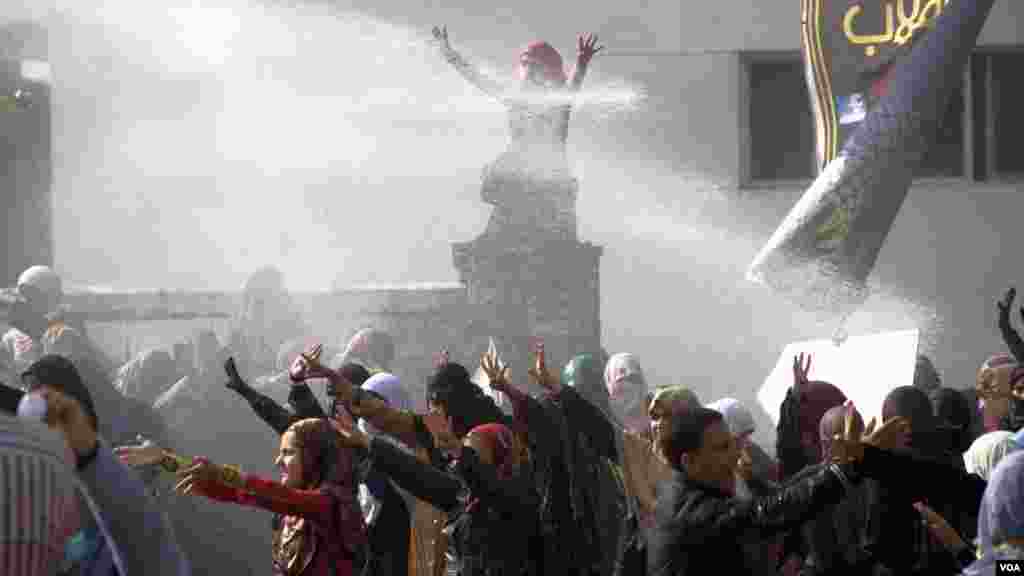 Water cannon are fired on female Islamist students during a protest at Al-Azhar University in Cairo, Dec. 11, 2013. (Hamada Elrasam for VOA)