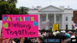 FILE - Activists march past the White House to protest the Trump administration's approach to illegal border crossings and separation of children from immigrant parents in Washington, June 20, 2018.