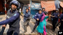 A Bangladeshi garment worker clashes with policemen during a protest in Savar, on the outskirts of Dhaka, Bangladesh, Jan. 9, 2019. 