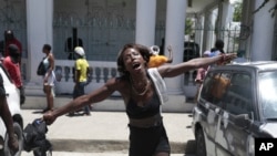 A woman shouts out how her family members died at the hands of gangs members in the Carrefour-Feuilles neighborhood, during a protest against insecurity in Port-au-Prince, Haiti, Aug. 25, 2023. 