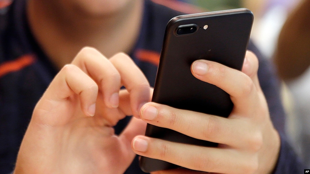 In this Sept. 16, 2017, file photo, a person uses a smart phone in Chicago. Most Americans across party lines have serious concerns about cyber attacks on U.S. computer systems and view China and Russia as major threats.
