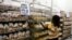 FILE - A worker arranges bread for sale inside a supermarket in Harare, March 26, 2009. 