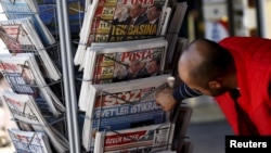 A man looks at newspapers at a kiosk in Diyarbakir, Turkey, Nov. 2, 2015.