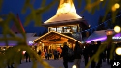 Tourists gather at Santa Claus Village, a winter-themed amusement park perched on the edge of the Arctic Circle, in Rovaniemi, Finland, Dec. 4, 2024. 