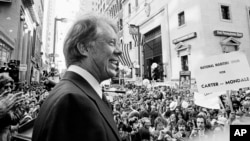 FILE - An estimated crowd of 35,000 people gather for a noontime speech by presidential candidate Jimmy Carter in downtown Philadelphia, Oct. 29, 1976.