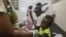 A child injured by the recent 7.2 magnitude earthquake is treated at the Immaculee Conception hospital in Les Cayes, Haiti, Thursday, Aug. 19, 2021. (AP Photo/Joseph Odelyn)